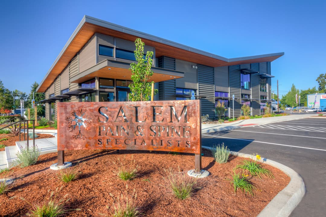 Salem Pain & Spine Specialists modern building exterior with landscaped entrance and sign.