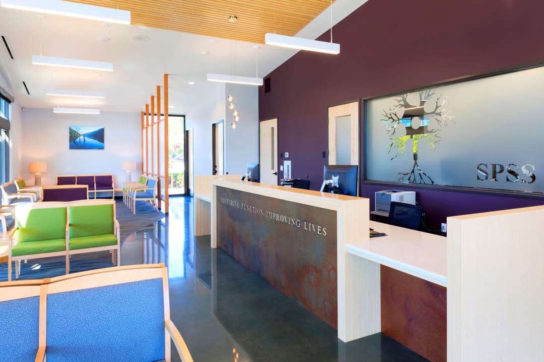 Modern reception area of SPSS with colorful seating and minimalist design.