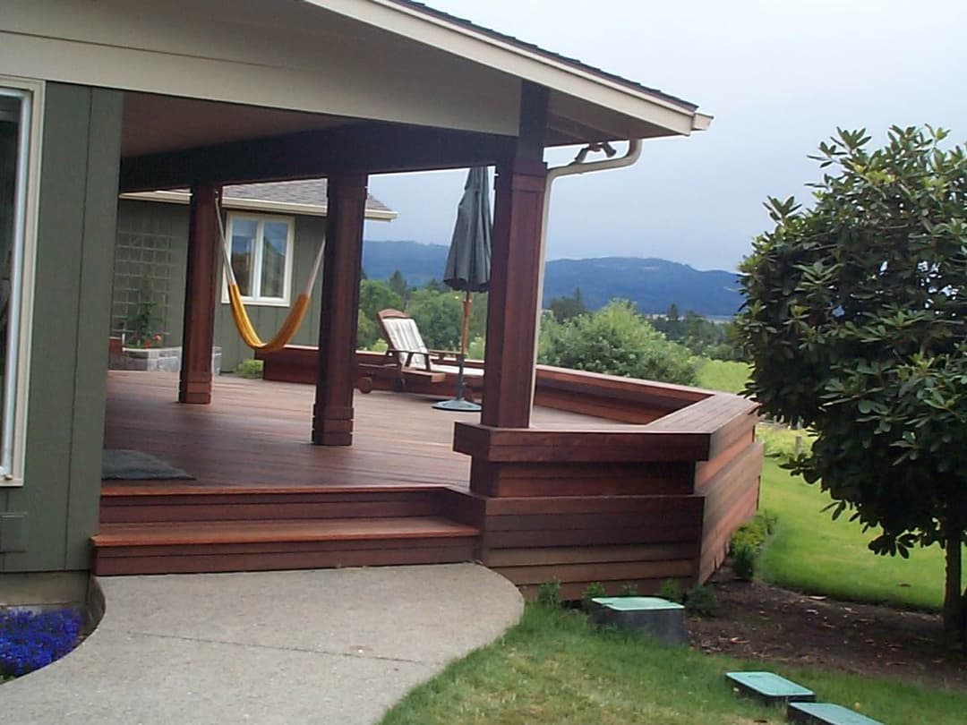Modern wood deck featuring seating, hammock, and scenic mountain view. Perfect outdoor retreat.