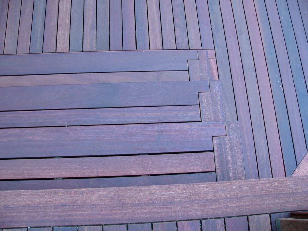 Close-up of intricately laid wooden deck showcasing rich color and detailed pattern.