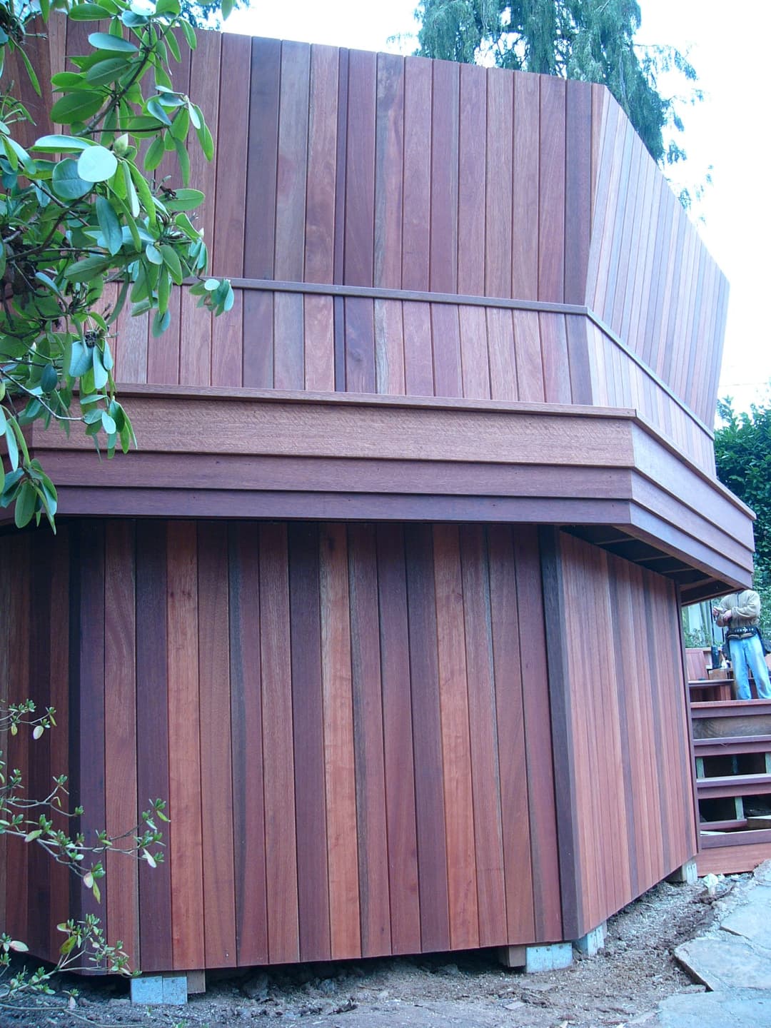 Modern wooden building exterior featuring vertical plank siding and a unique angled design.
