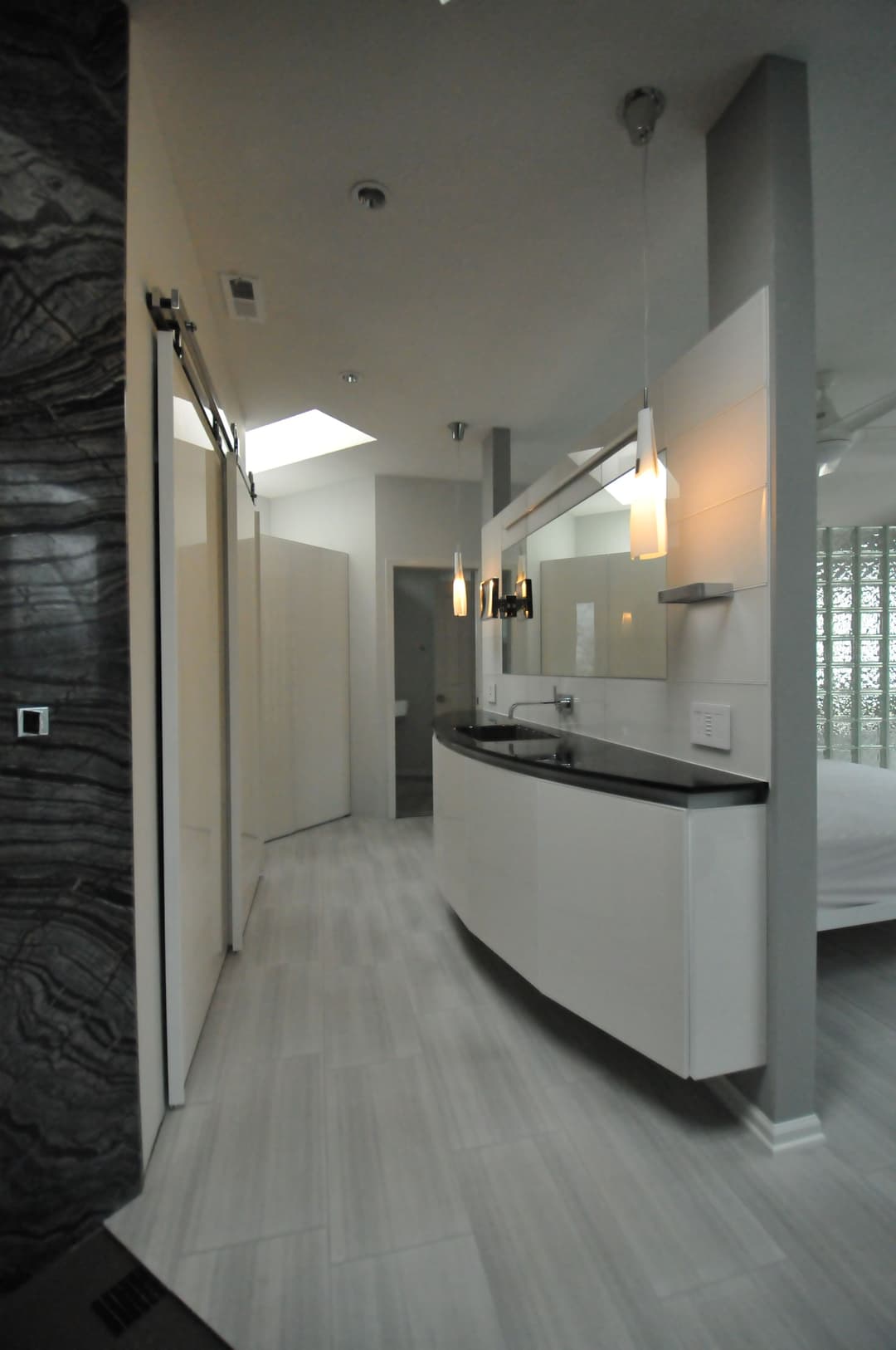 Modern bathroom design featuring sleek vanity, glass accents, and natural light.