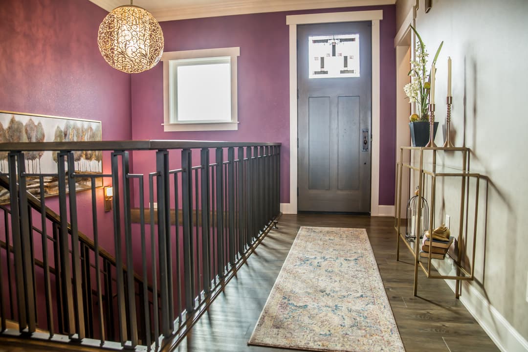 Elegant purple hallway featuring a decorative light fixture and stylish entryway decor.
