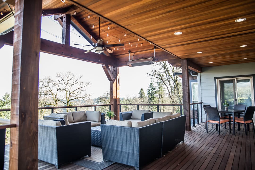 Modern outdoor living space with stylish seating and scenic views on a wooden deck.