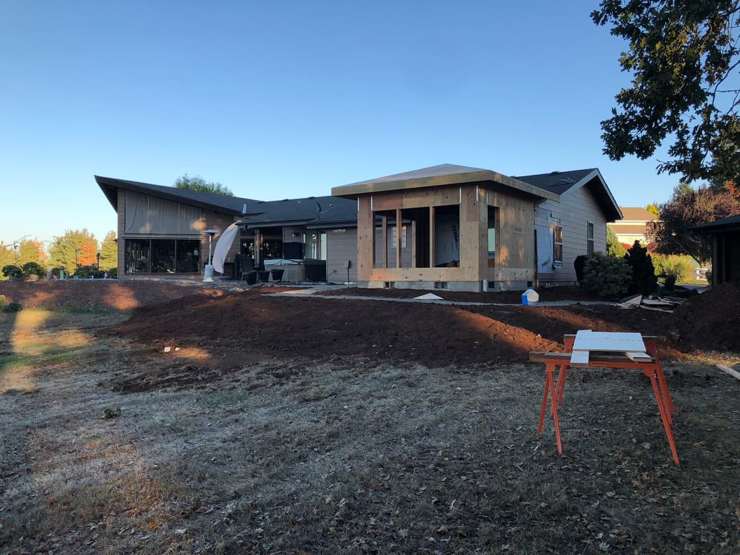 Home renovation project with new exterior construction in a residential yard.