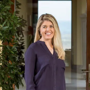 a woman standing in front of a window