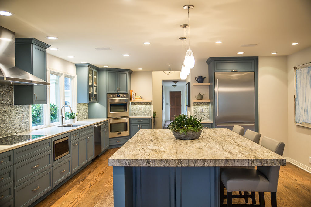 a kitchen with an island in the middle of a room