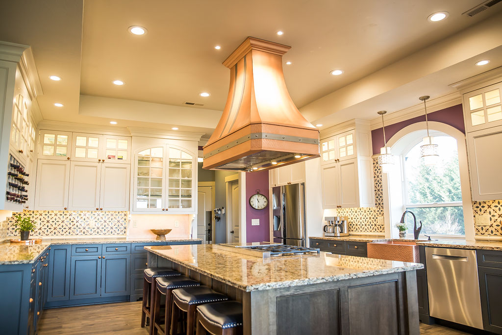 a kitchen with an island in the middle of a room